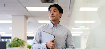 Homepage-business-bucket business student at North Park University holding notebook