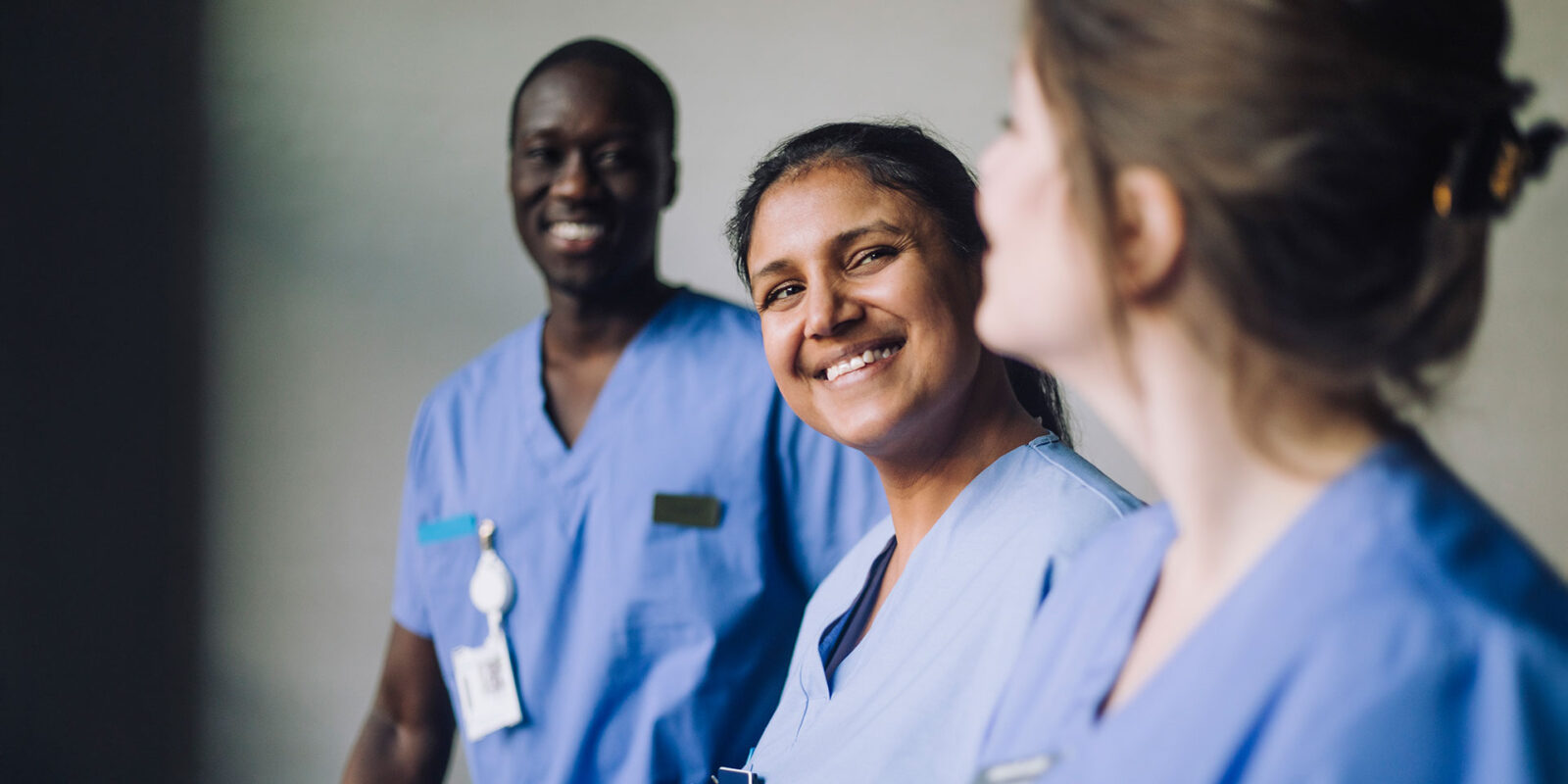three nursing students in scrubs